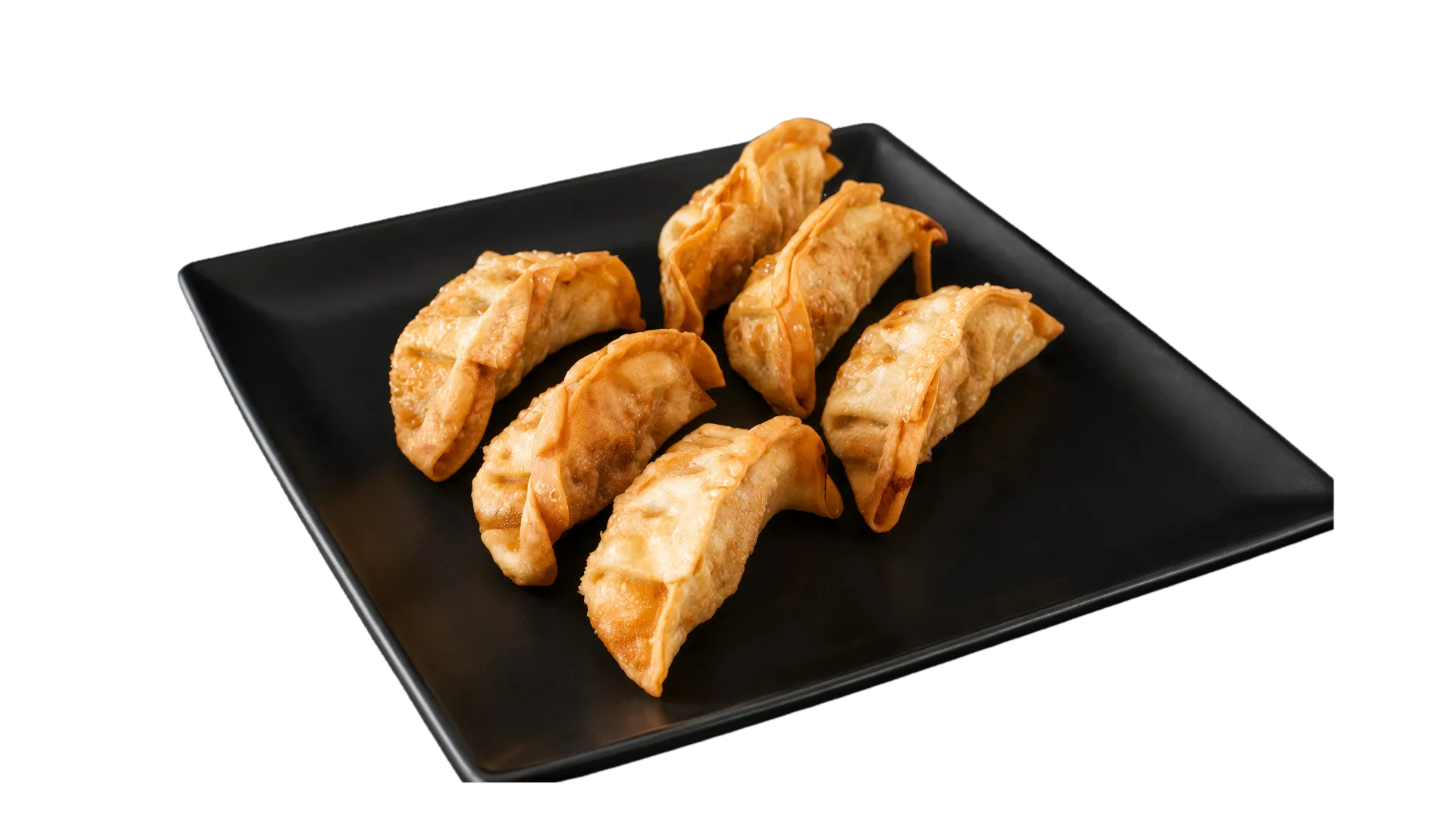 Golden fried pot stickers served on a black plate Golden fried pot stickers served on a black plate