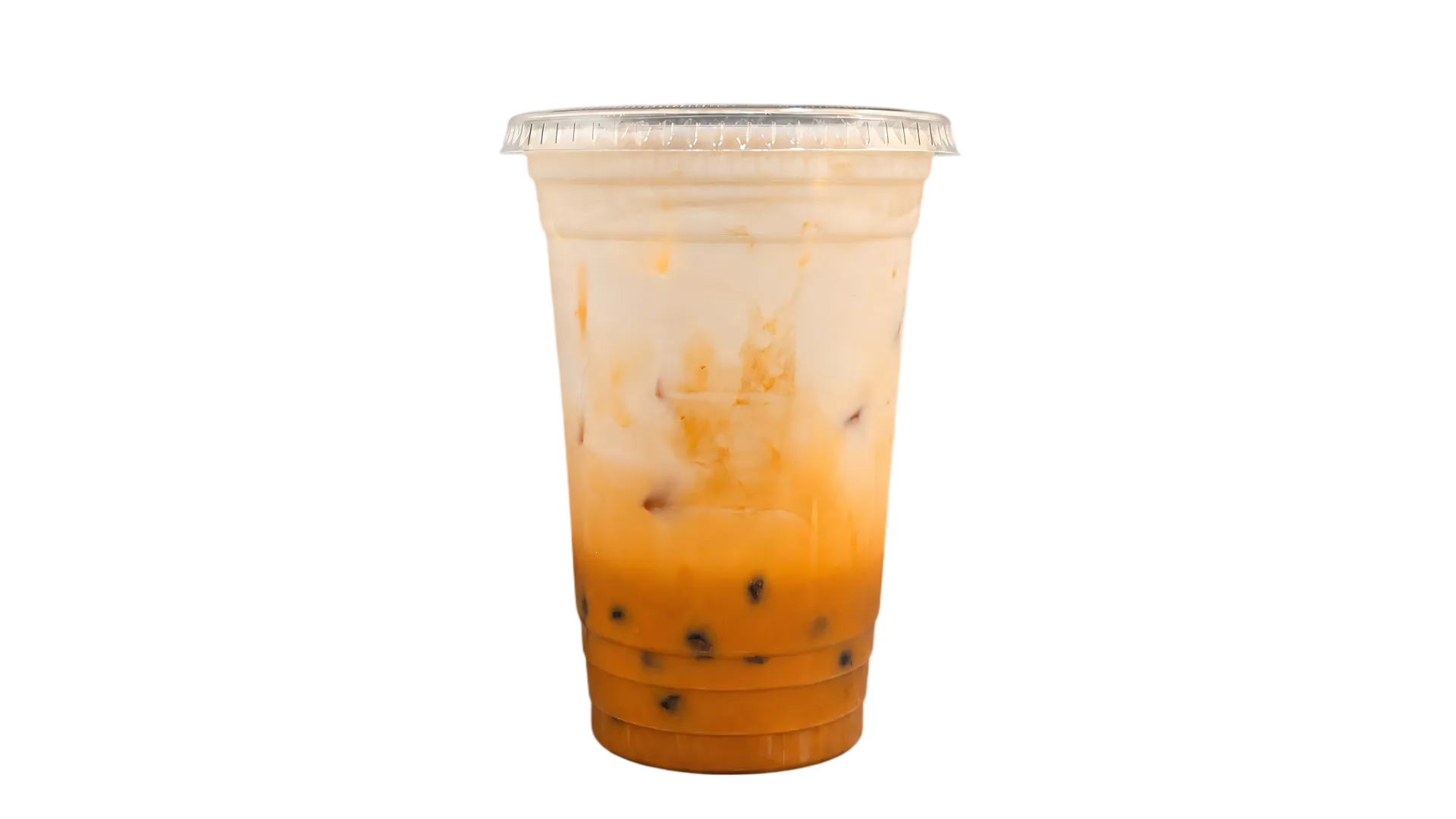Thai iced tea with creamy milk and ice in a clear cup Thai iced tea with creamy milk and ice in a clear cup
